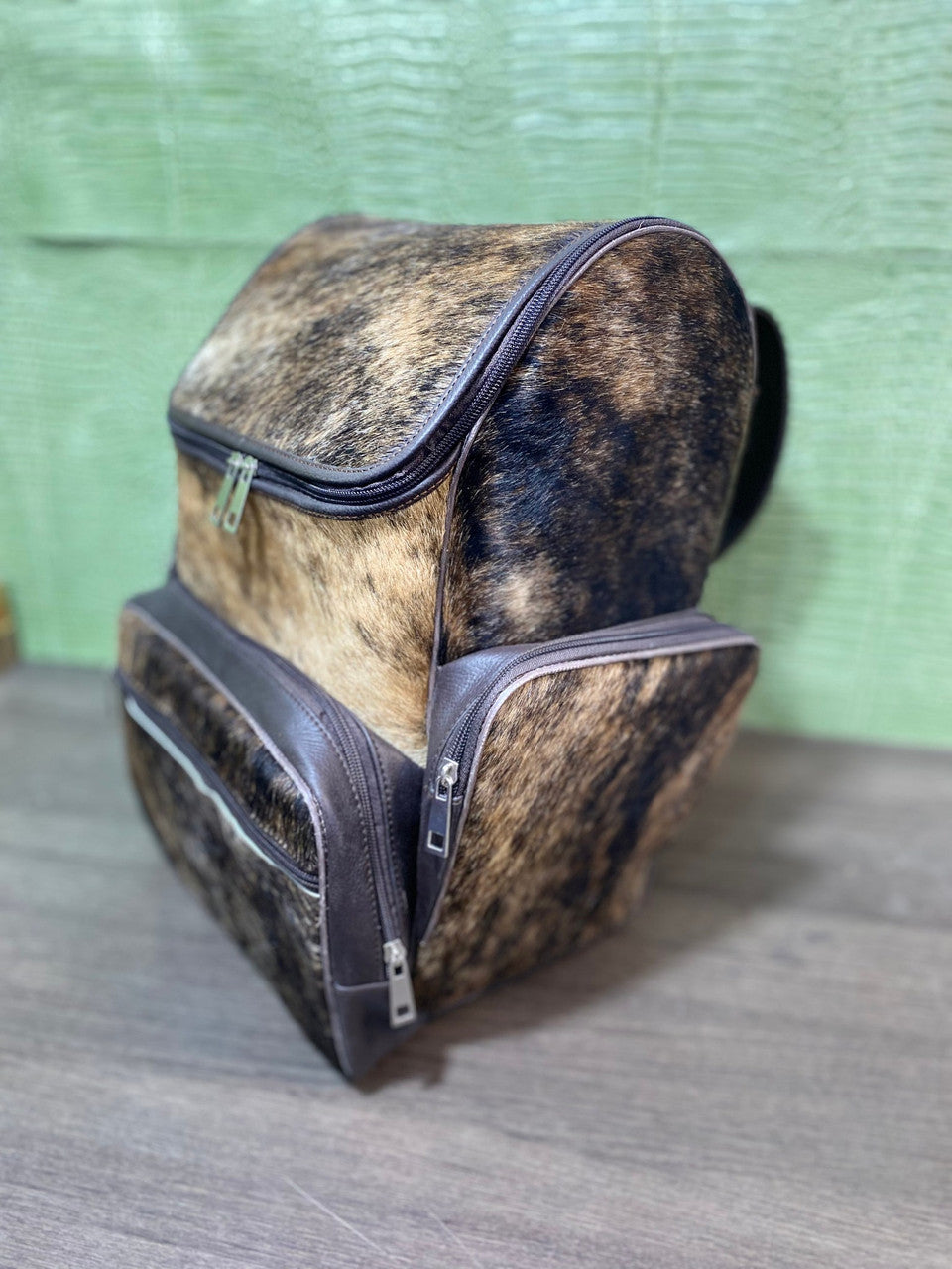 Our custom-made brindle brown cowhide backpack is a must-have for any occasion. Its unique pattern adds a touch of personality to your look, while its soft and smooth texture ensures maximum comfort and convenience.