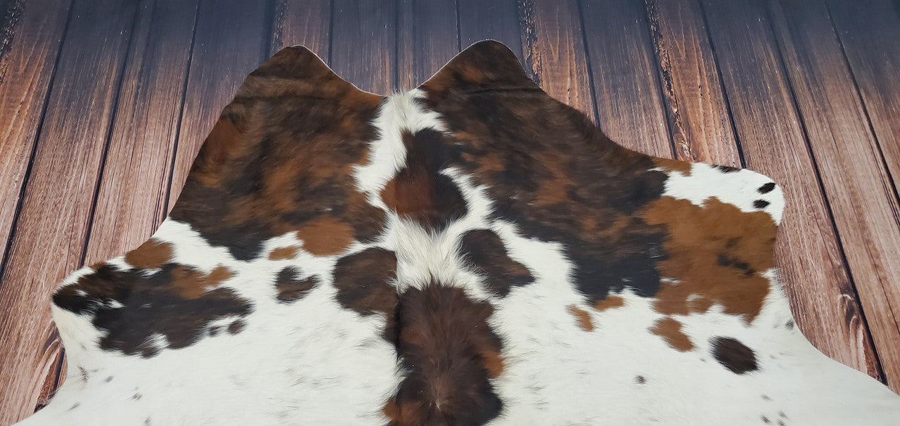 Discover the timeless elegance of a speckled tricolor cowhide rug, ideal for enhancing any room.