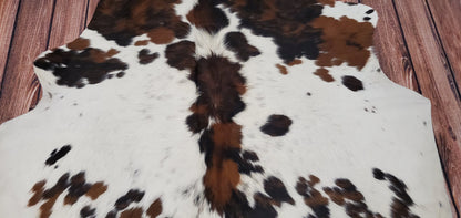 Elevate your interior design with a versatile speckled tricolor cowhide rug, suitable for any home space.