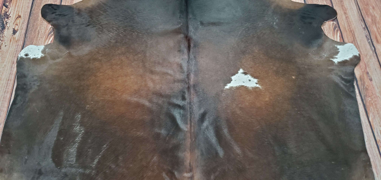 Bring a stylish and elegant touch to your home with this natural cowhide rug in a unique combination of dark brown and black.