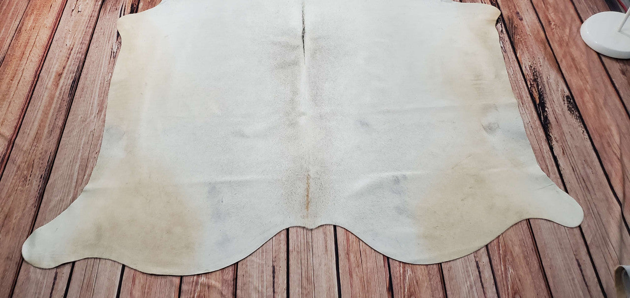 Create a cozy, natural atmosphere in your home with an ivory cowhide rug. Enhance the look and feel of any room with this elegant and timeless piece.