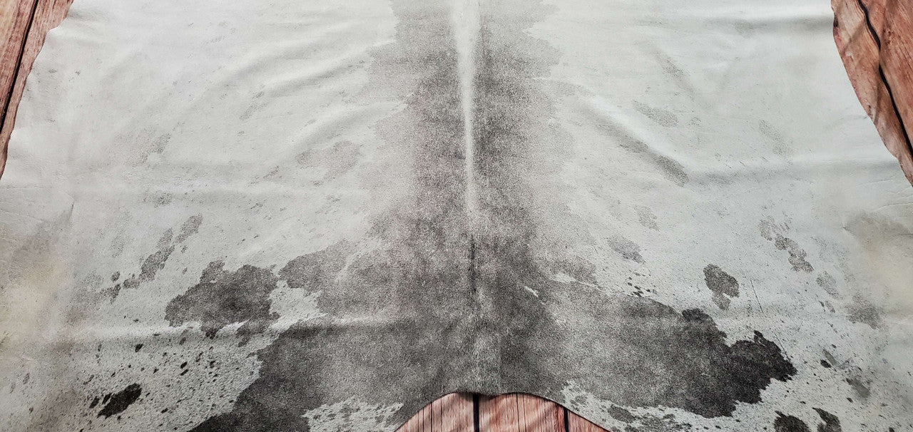 Indulge in luxury with our grey white cowhide rug, a statement piece for any room.