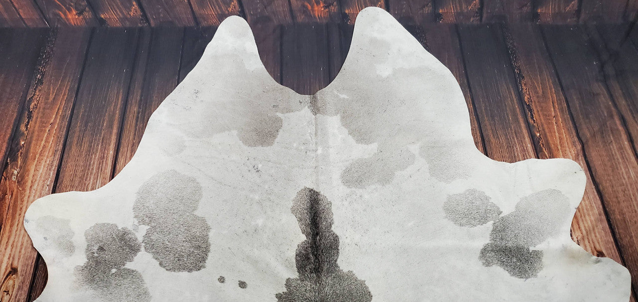 Luxurious grey white cowhide rug: timeless elegance for any space. Soft, durable, and naturally beautiful.