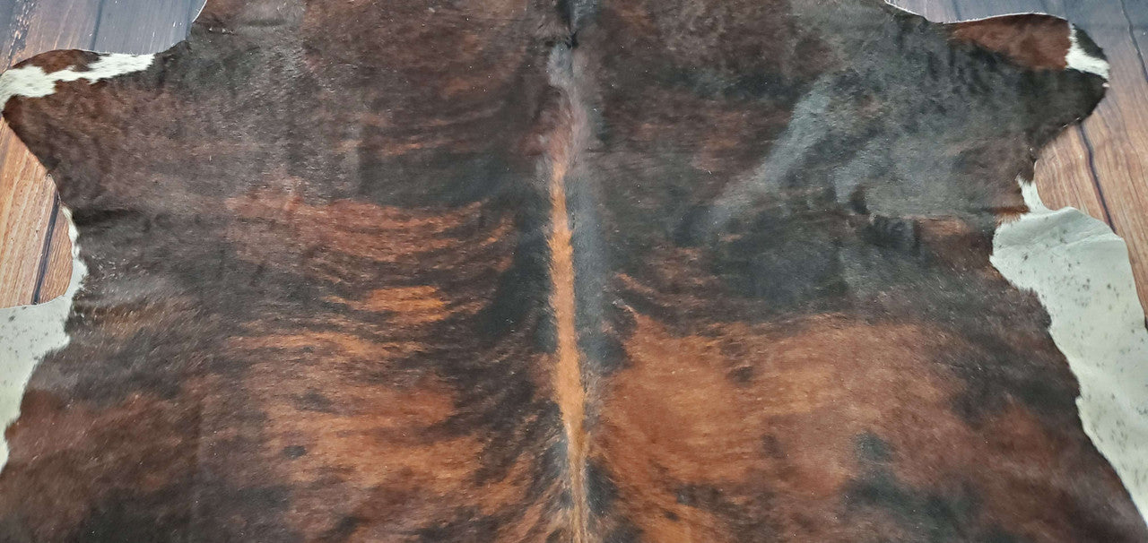This beautifully large brown white cowhide rug is perfect for my room! It fits perfectly in there and will be an incredible addition. It is such a high-quality rug too.