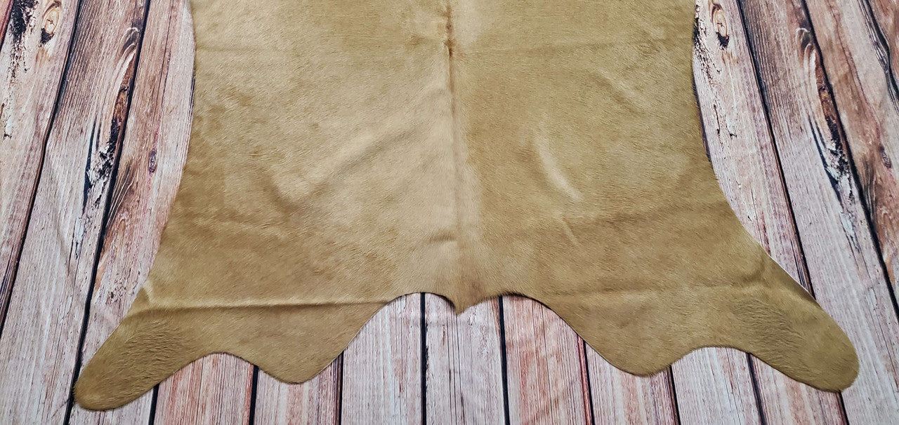 A small cowhide rug is the perfect addition to any living room or small space. The tan colors are great for any décor, and the rug can be hung on the wall.