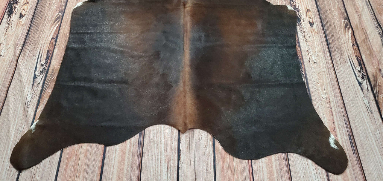 Each dark brindle cowhide is carefully handpicked to ensure unparalleled softness and durability. Not only do they exude elegance, but these cowhide rugs also offer practicality as they naturally resist stains, making them ideal for high-traffic areas or homes with pets and children.