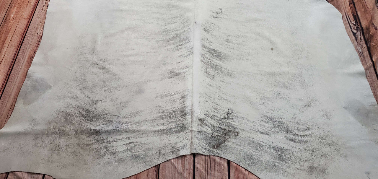 A warm brindle cowhide rug that looks beautiful. It's soft and beautiful to the touch. It can be used in any space.