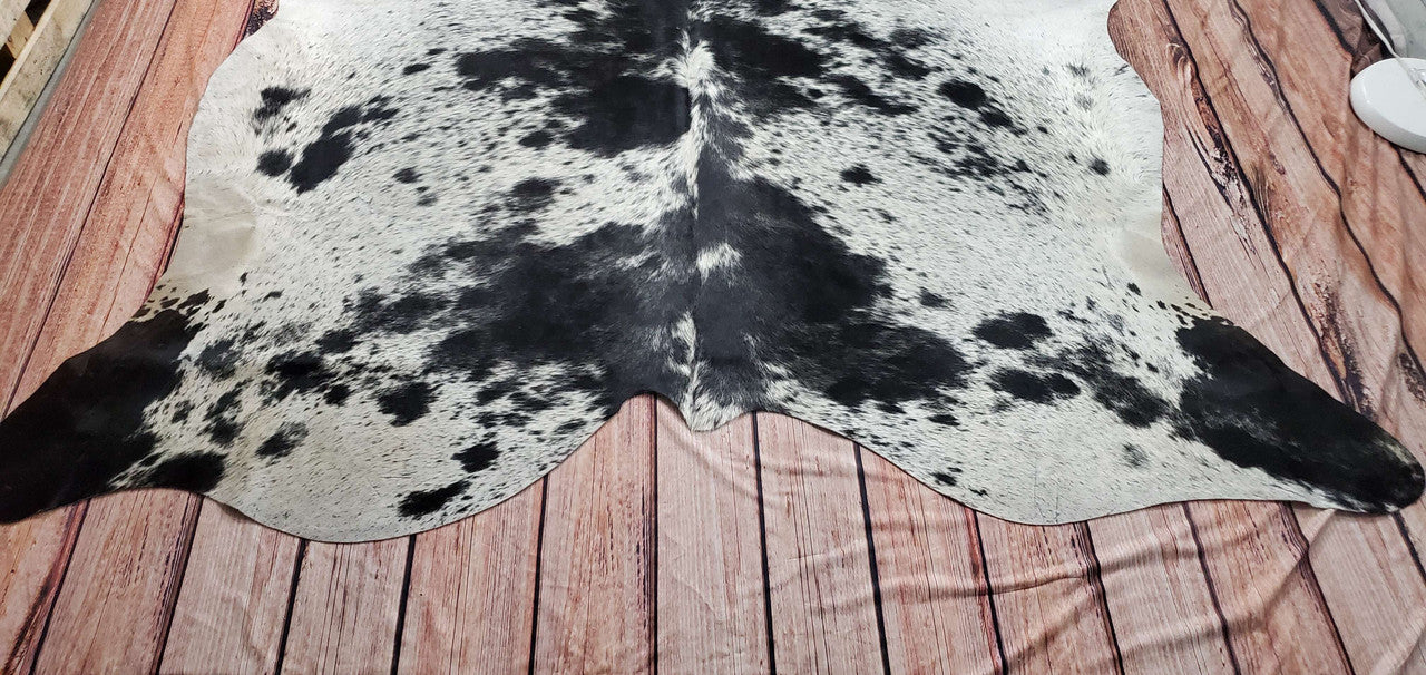 This one-of-a-kind speckled cowhide rug is ideal for living rooms, as its unique black and white design ties in any decor. It is very soft and smooth to the touch, and very soft to be walked on.