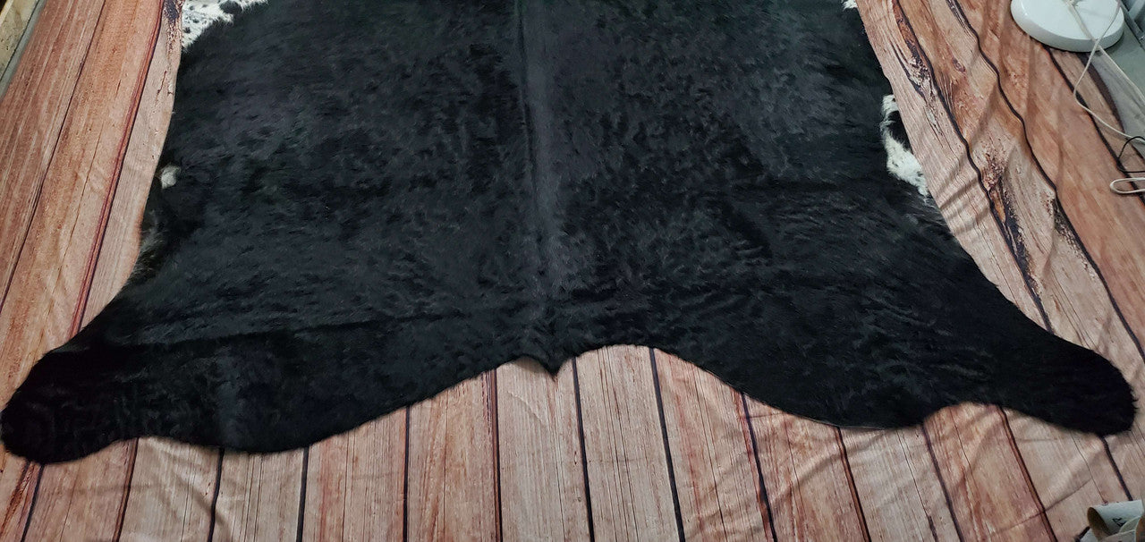 A natural cowhide rug in large size creates a quiet atmosphere, neat and soft, a perfect fit for any room.