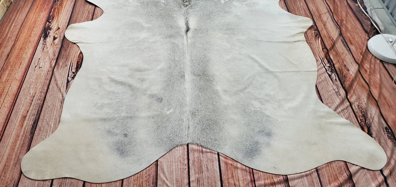 A neutral cowhide rug can quickly polish up a room that might appear cold and dull.