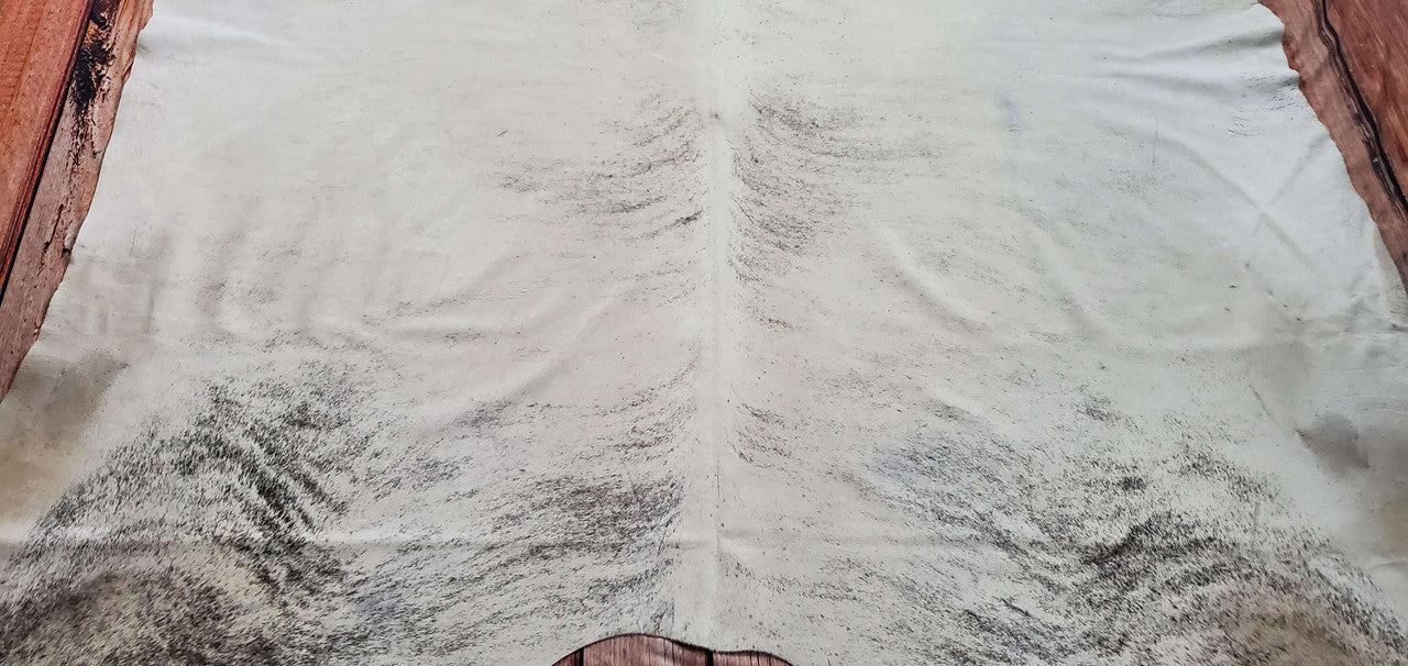 A natural grey brindle cowhide rug in grey ivory, an amazing color, offers a striking focal point in any setting, and get it anywhere in Canada within one to four business days.