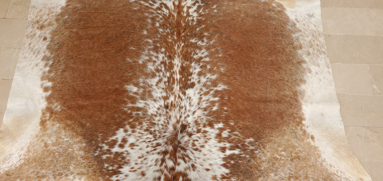 Bring your office to life with this stunning and unique geniune speckled cowhide rug! This rugged addition is sure to create a warm, inviting atmosphere in any workspace.