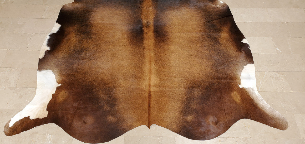 Cowhide rugs is a design trick that is inexpensive and brown brindle in small size can change the way your space looks.