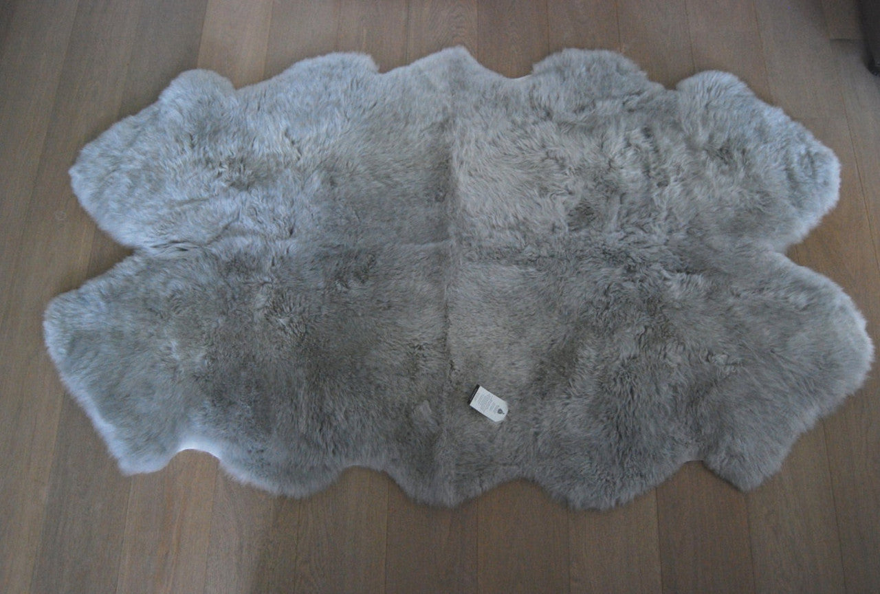 Elevate your space with a plush grey sheepskin rug - the perfect blend of luxury and comfort. 
