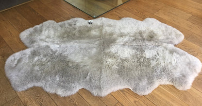 Add a touch of sophistication to your home with a stylish grey sheepskin rug, offering warmth and elegance.