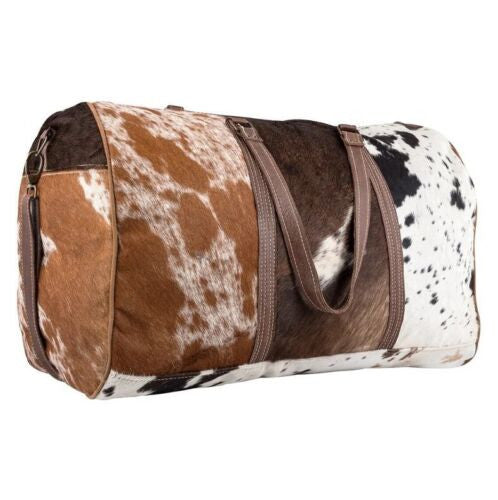 This cowhide bag spacious design allows you to store all your essentials while on the go. Whether it's for work or leisure, the perfect bag is always within reach.