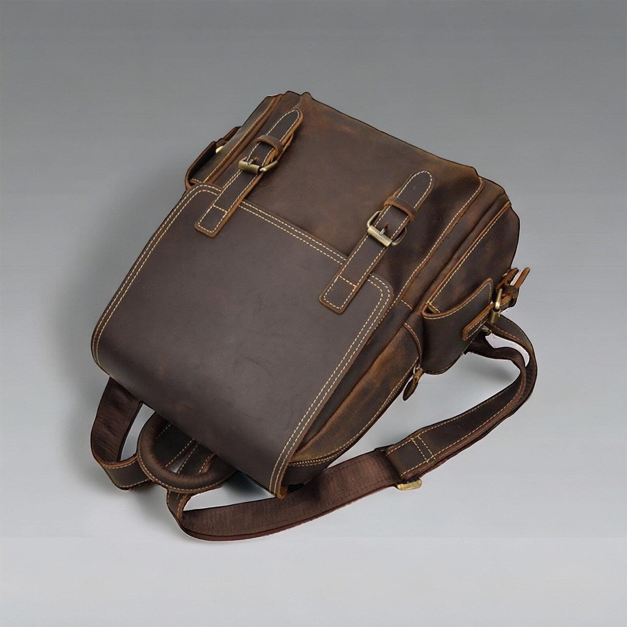A lifestyle image capturing a person wearing a stylish leather backpack while walking through an urban setting. The sleek silhouette and minimalist design of the backpack complement the individual's modern attire, adding a touch of sophistication to their ensemble. The bag's clean lines and subtle embossed logo reflect understated luxury and timeless appeal.