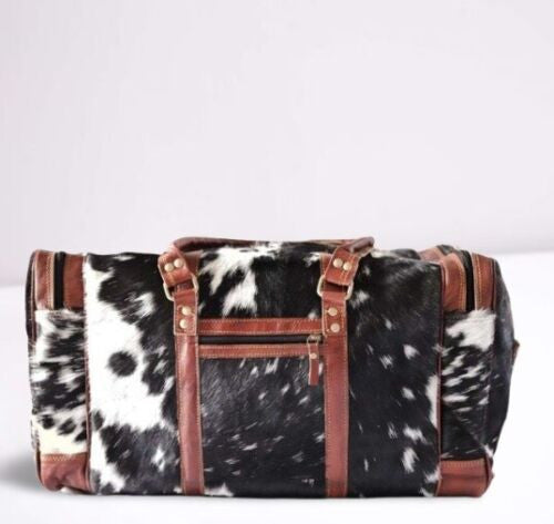 Cowhide duffel bag in tricolor leather patches is the perfect way to bring a little bit of style and sophistication to any outfit. Crafted with genuine leather, this beautiful duffel bag has multiple compartments and pockets to store your belongings safely and securely.
