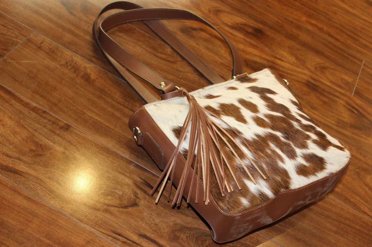Buy this brown white cowhide bag in messenger style buy it as a gift for your family and give a touch of western.