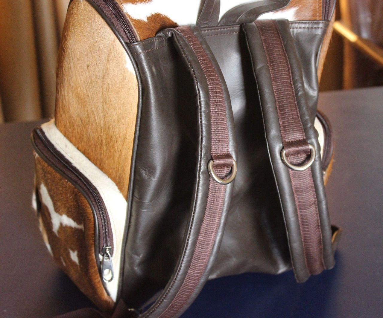cowhide leather backpack is one handmade from real and natural hair on cow hide.