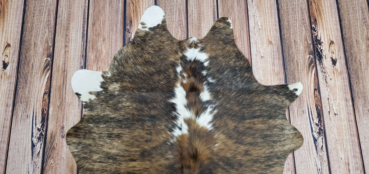 The natural markings on the cowhide give it a unique look that will add character to any room.