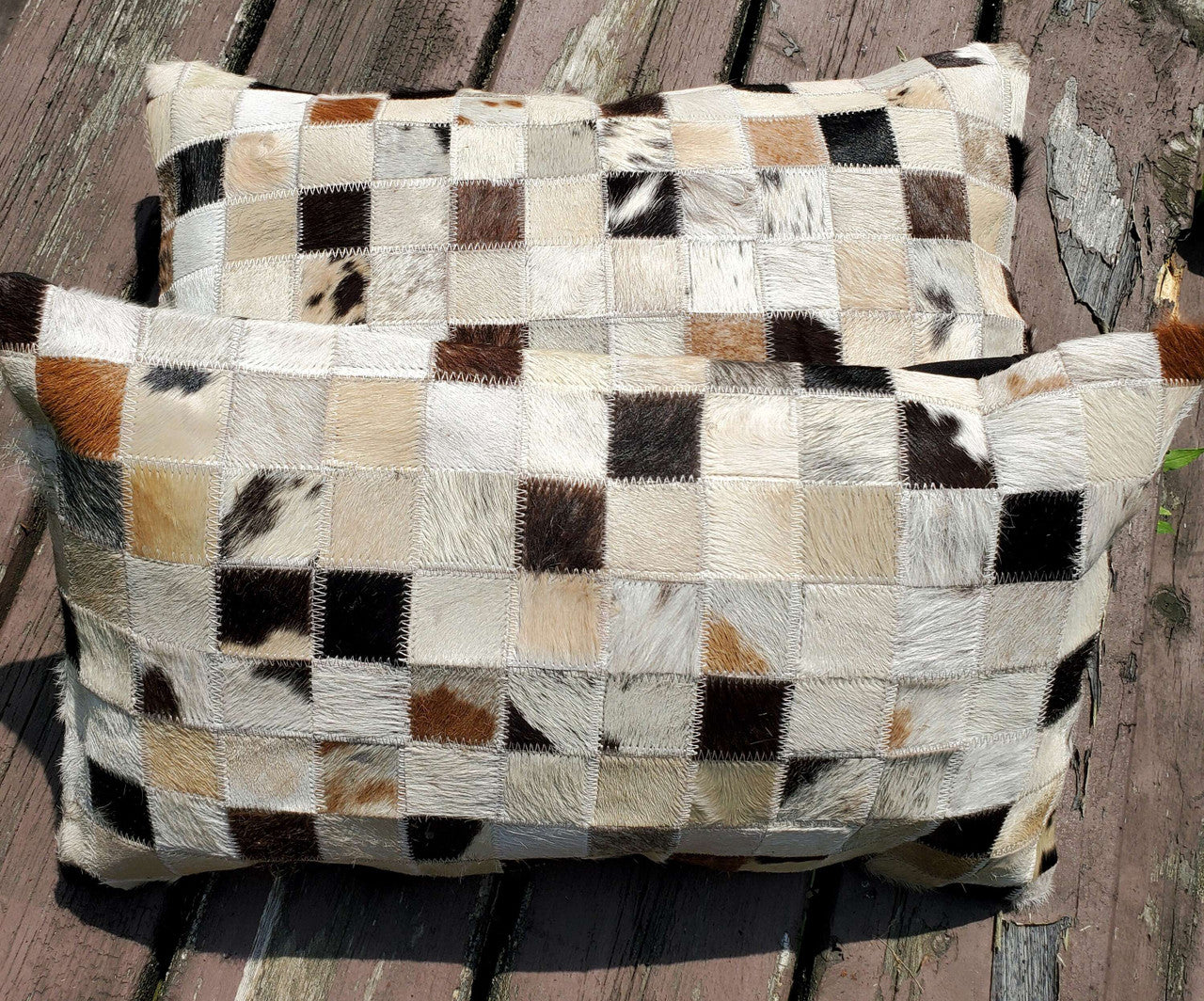 Cowhide pillows that are nicely made and shipped just in time for in-laws to come over and think you have your decor & life together