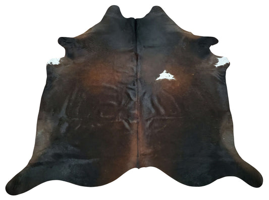 An amazing-looking dark brown-black cowhide rug, lovely texture and pure natural and real, this cowhide gives a room a natural and calm feeling.