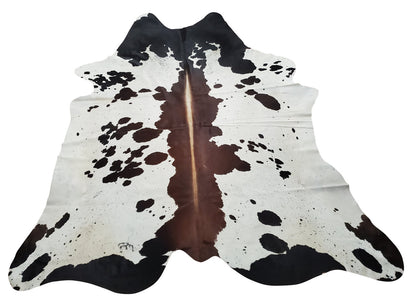 Stunning Cowhide rug in a unique and exotic pattern, gorgeous mix of mostly brown with some black and white. 
