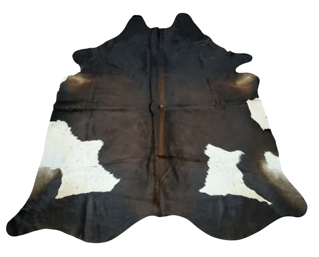 Dark cowhide rugs on light flooring is a classic pairing that can bring an extra level of sophistication and style to any space.