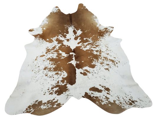 Spotted cowhide rug in extra large is something trending this year, a pouf in a natural inspired boho inspired living room is a perfect choice.