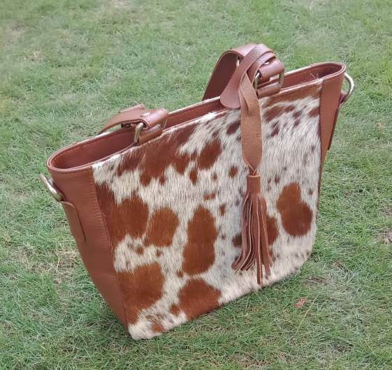 A top quality light brown white cowhide tote bag made from real top quality leather, great for new years.