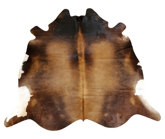 A very beautiful small cowhide rug mostly brown with white edges, amazing for high traffic living room.