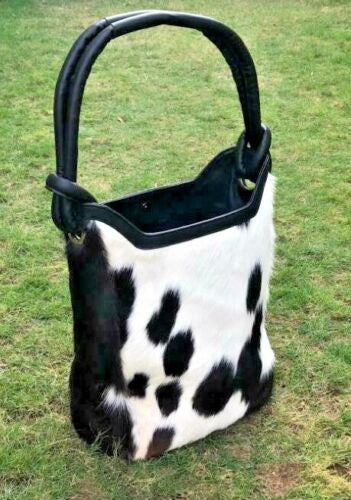 A black and white cowhide bucket bag is an easy to handle, it is custom made and one of a kind and no one can copy it.