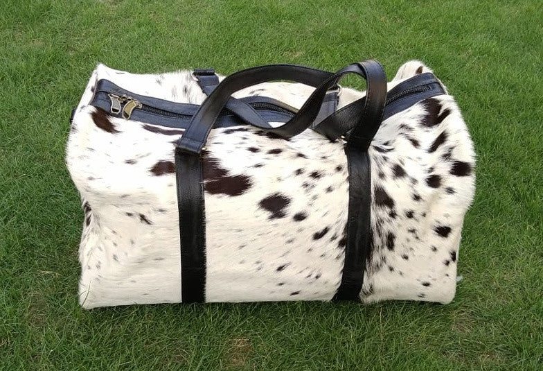 Fast shipping on all our beautiful cow skin bags in black white real cow skin, definitely enjoy using this cow skin bag daily.