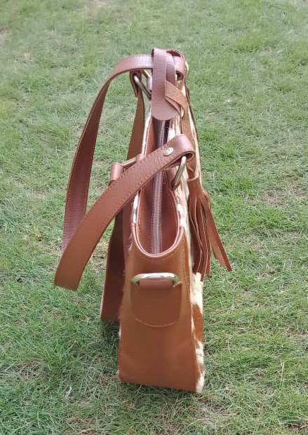 Another beautifully handmade cowhide purse in a rich expresso chocolate toning, hair on Fur on both sides very light to wear.