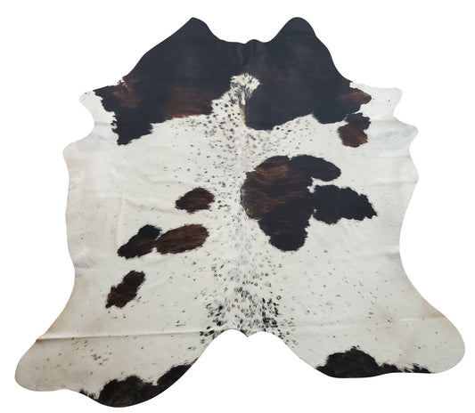 Beautiful extra large cowhide rug in tricolor, soft and well treated perfectly white, brown, and black looks great dark hardwood floor, It is a standout.