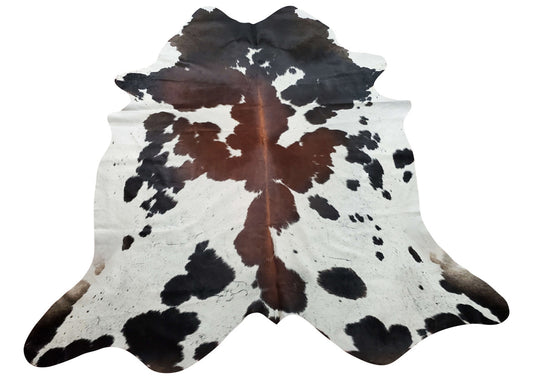 Make a statement with this stunning tricolor cowhide rug. A unique combination of faded brown, black and white on the edges, cowhide will add elegance
