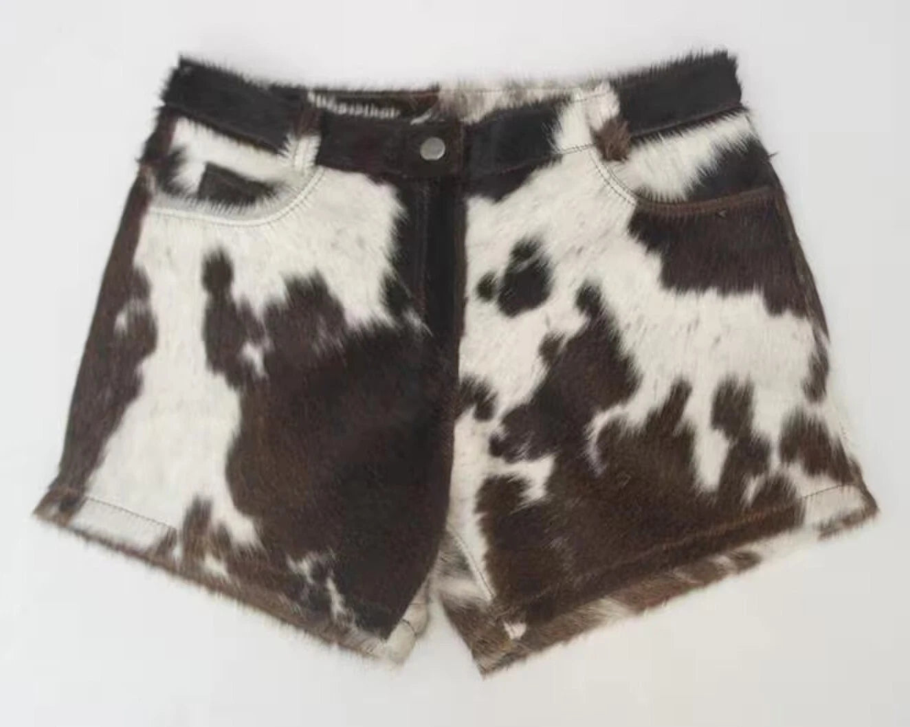 Turn heads with real cow skin shorts for women. These women mini cowhide shorts feature natural brown and white cowhide, ideal for rodeo, ranch wear, or bold summer styling.