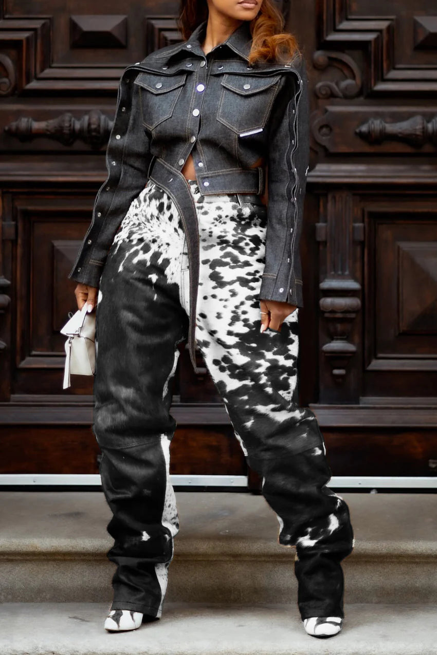 High-waist black white cowhide pants made from real cow skin leather. Unique hair on hide trousers with bold cow print for standout western fashion.