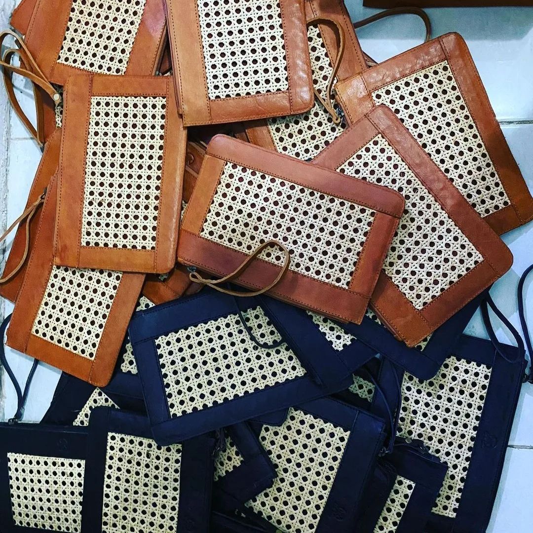 Nahaufnahme der geflochtenen Rattanstruktur und Lederkante der schwarzen Clutch