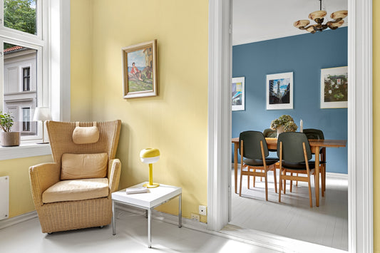 A living room with yellow walls and chairs