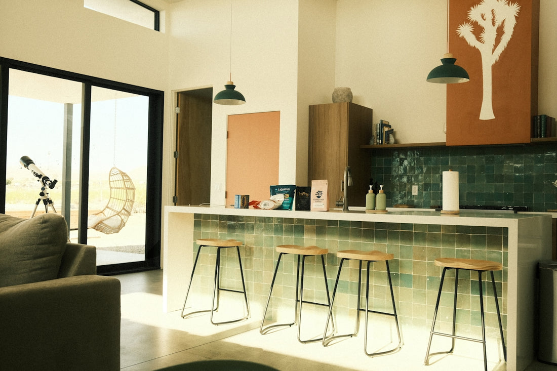 An interior shot shows a modern kitchen and living room.