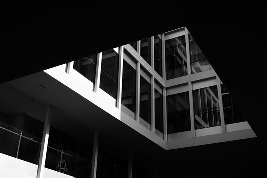 Modern building with glass windows against black background