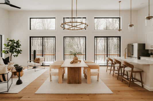 Modern dining and living area with large windows.