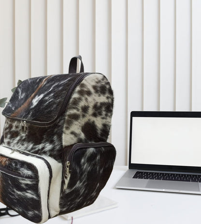 This one-of-a-kind speckled cowhide backpack will elevate your style. With its versatile design and comfortable fit, it's perfect for any adventure. Get yours today!