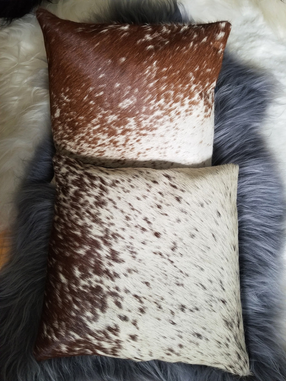 two cowhide pillow covers