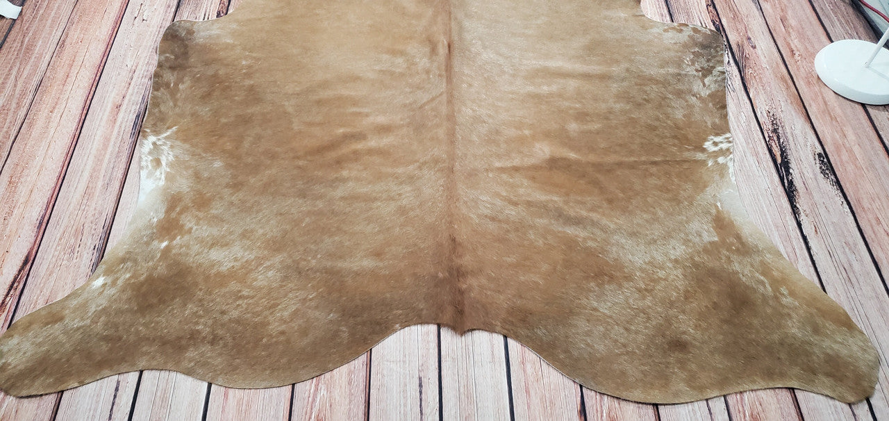 Beige cowhide rugs have been popular for centuries due to their attractive appearance as well as their natural insulation properties meaning they help keep rooms warm during winter months.