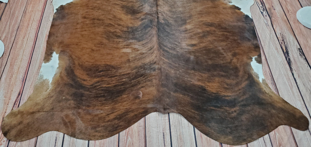 Transform your space into a cozy rustic oasis with this dark brown cowhide rug! With its comforting vibes, add a touch of comfort and style to any room. 