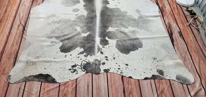 This grey white cowhide rug is perfect for the any space and it will warm up the living room!