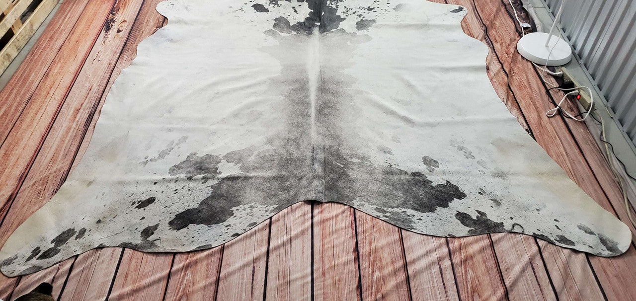 Enhance your decor with the natural beauty of our grey white cowhide rug - a true masterpiece.